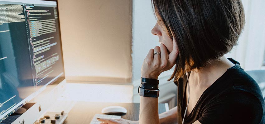 A woman sitting at a computer.