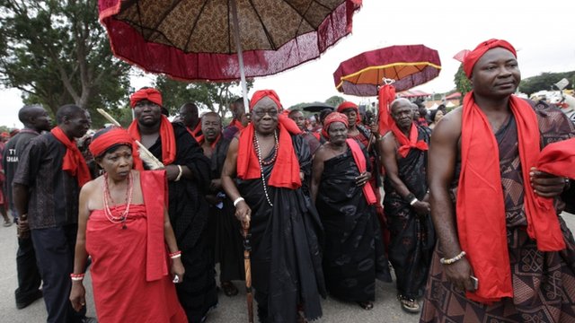 Ghanaians attired in traditional funeral colors