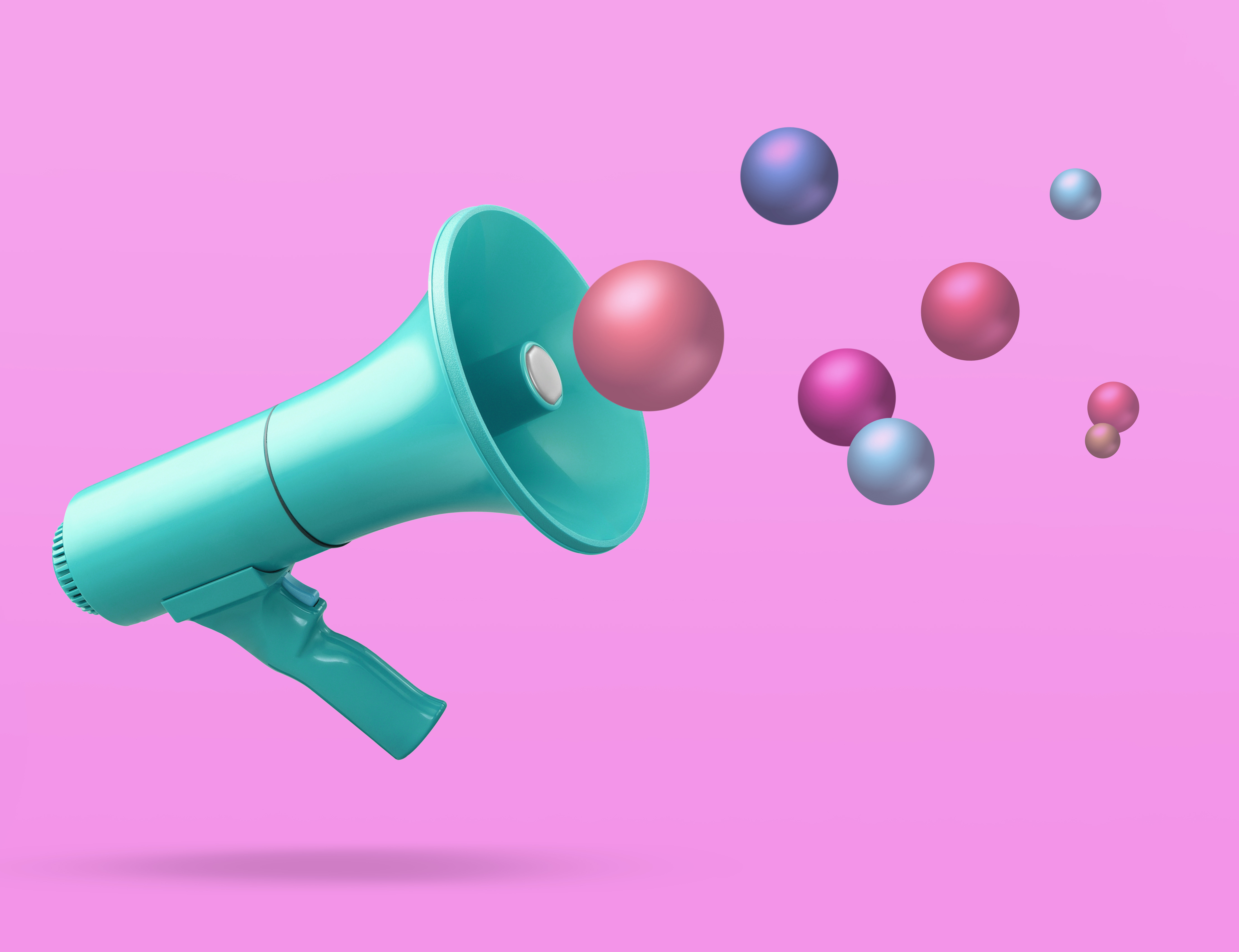Image of a megaphone on a pink background with colorful balls in the air to represent marketing.