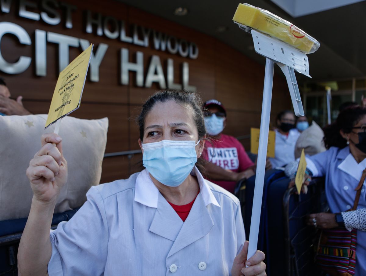A group of West Hollywood hotel workers and their supporters march and demonstrate ahead of a City Council vote on a hotel worker protection policy