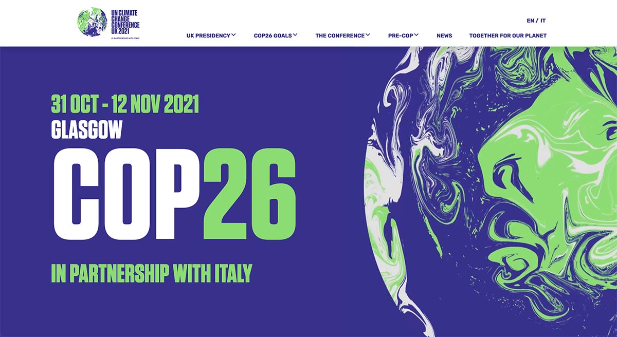Screenshot of the COP26 homepage with a deep blue background, bold white and green lettering on the left with the conference dates, and a swirly illustration of Earth on the right in green and white.