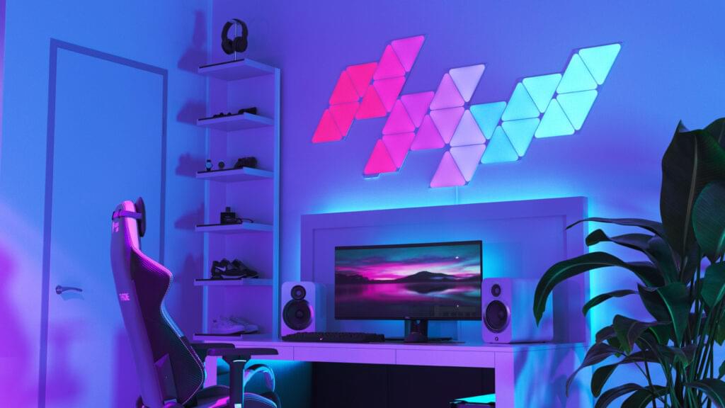 A funkily lit office space, with a collection of Nanoleaf smart lights on the wall