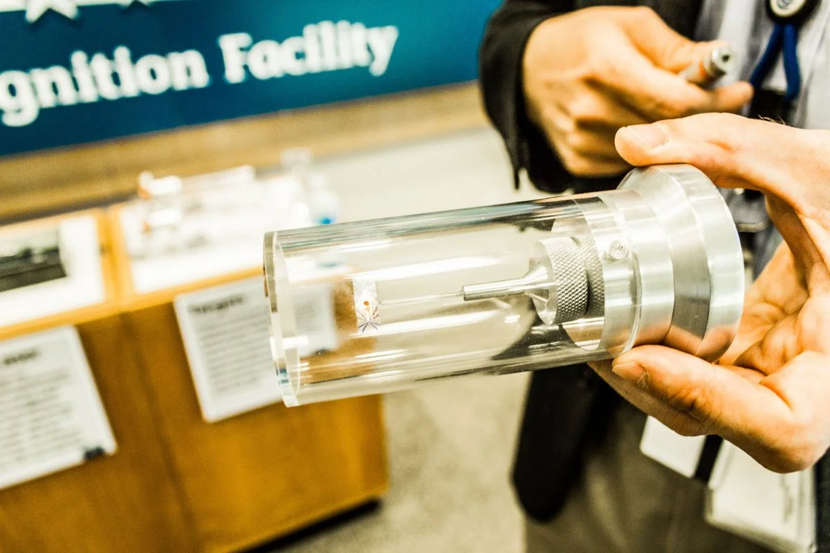 A researcher holds a fusion fuel target