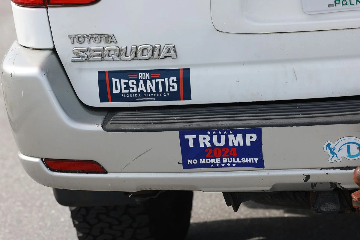 A Florida Gov. Ron DeSantis sticker and one reading, ‘Trump 2024 No More Bullshit’, are plastered on a vehicle near the Mar-a-Lago home of former U.S. President Donald Trump before he speaks this evening on November 15, 2022 in Palm Beach, Florida